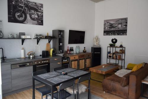 a living room with a couch and a table at Auszeit by Kirschner in Mönchhof