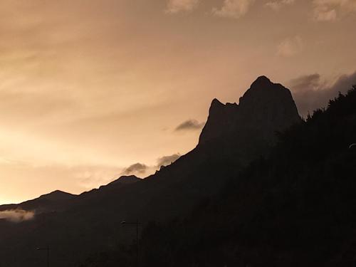 a silhouette of a mountain at sunset at Hotel La Casueña in Lanuza