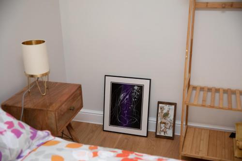 a bedroom with a bed and a picture on the wall at Stylish one bed apartment in the Stroud Valleys in Brimscombe
