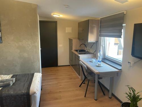 a small kitchen with a desk and a table at L'Imeri Residence in Reilingen