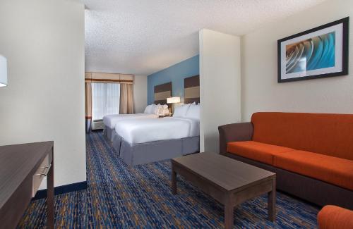 a hotel room with a bed and a couch at Holiday Inn Express Berea, an IHG Hotel in Berea