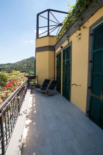 two chairs on the balcony of a house at Hotel Ca' di Gali in Sasso Marconi