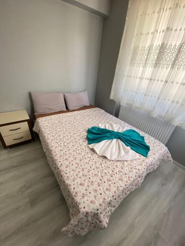 a bedroom with a bed with a comforter on it at dagkent plus suit in Tokat