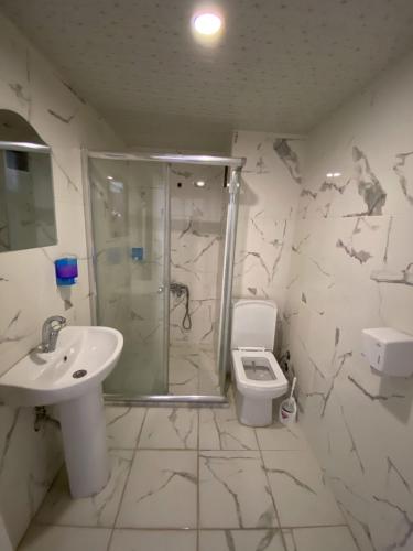 a bathroom with a shower and a sink and a toilet at dagkent plus suit in Tokat