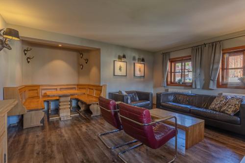 a living room with a couch and a table at Das Schmiedhaus in Kaprun