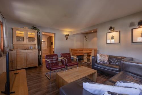 a living room with a couch and a table at Das Schmiedhaus in Kaprun