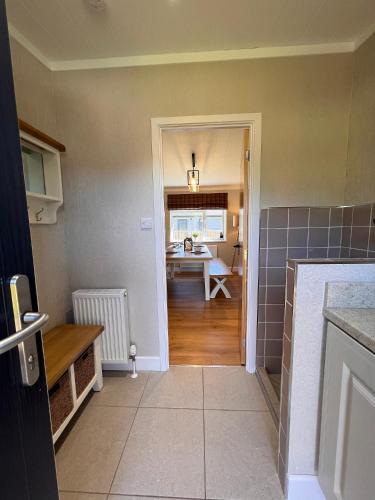 a kitchen with a table and a dining room at Hollicarrs - Dragonfly Lodge in York