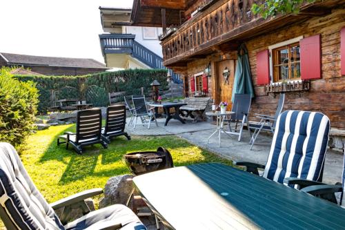 a patio with chairs and a table and a table and chairs at Das Schmiedhaus in Kaprun
