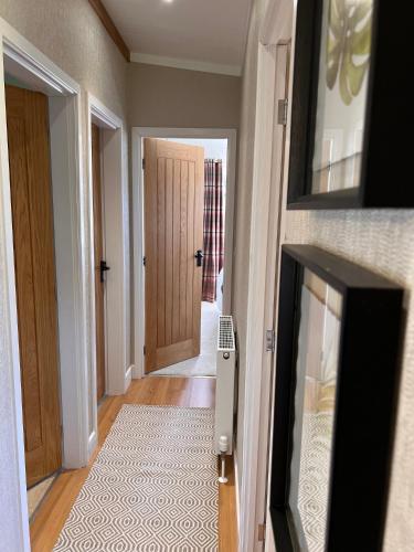 a hallway with a door leading into a room at Hollicarrs - Dragonfly Lodge in York