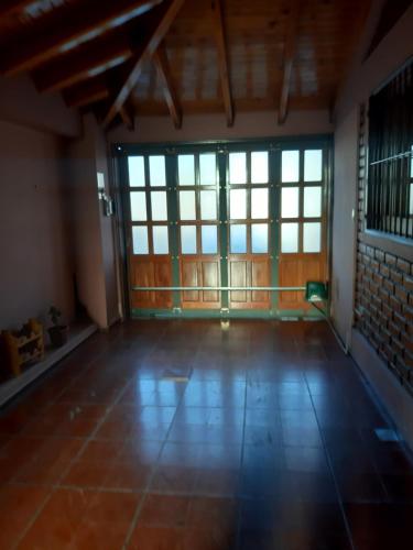 an empty room with windows and a tiled floor at KARMEL "tu lugar' in Maipú