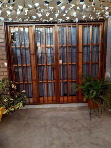 a room with wooden doors and glass windows at KARMEL "tu lugar' in Maipú