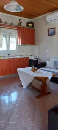 a kitchen with a table in the middle of a room at Our Country House in Vergia