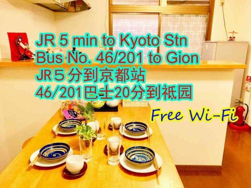 a picture of a table with plates on it at Kyoto Nijo Traditional House in Kyoto