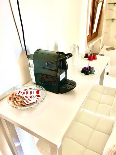 a white table with a toaster and a plate on it at Villa Latino in Vieste