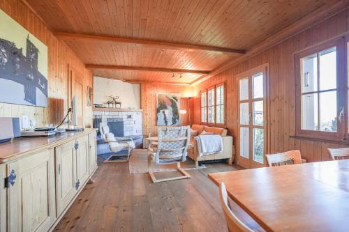 a kitchen and living room with a table and chairs at Chalet Mungg in Bettmeralp