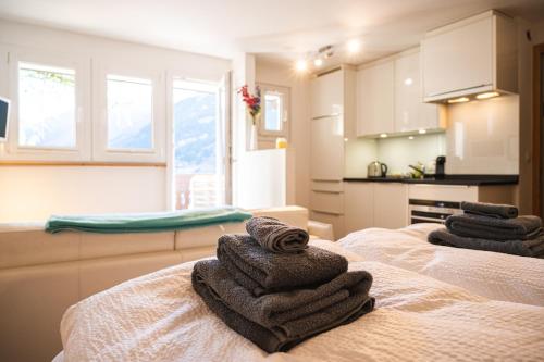 two towels sitting on top of two beds in a kitchen at Studio direkt im Zentrum, tolle Terrasse, Aussicht in Zermatt