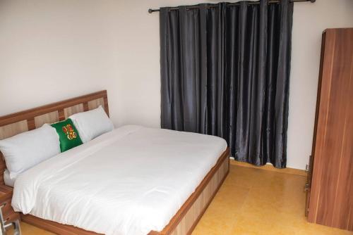 a bedroom with a bed and a black curtain at William Ofori-Atta Fie in Accra