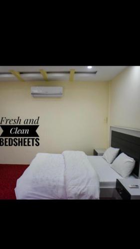a bedroom with two beds and a sign on the wall at SWAT HiLL ViEW RESORT-only for families in Swat