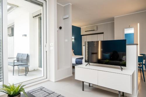 a living room with a flat screen tv on a white cabinet at Viam Imbriani Suites in Rome