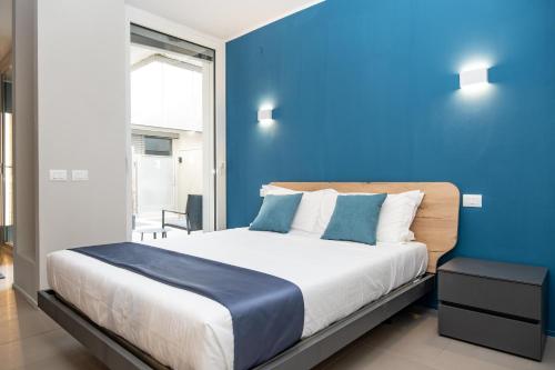 a blue bedroom with a bed with a blue wall at Viam Imbriani Suites in Rome