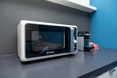 a microwave sitting on a counter in a kitchen at Viam Imbriani Suites in Rome