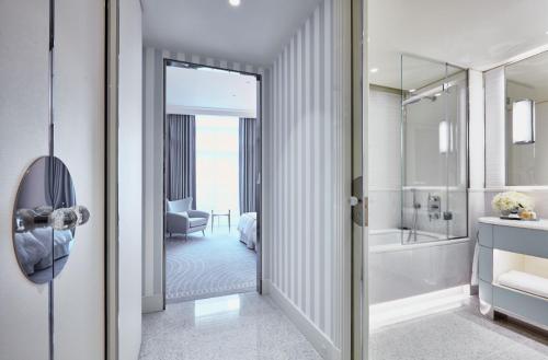 a bathroom with a walk in shower and a tub at Hôtel Martinez, in The Unbound Collection by Hyatt in Cannes
