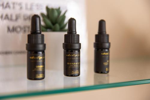 three bottles of essential oils sitting on a shelf at The Bridge Hotel and Spa in Wetherby