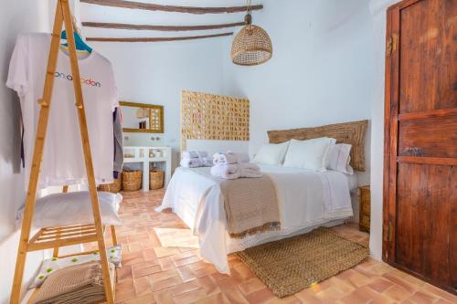 Un dormitorio con una cama blanca y una escalera en Casa Familiar en pleno Casco Antiguo de Altea, en Altea