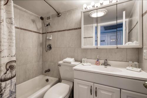 a bathroom with a sink and a toilet and a tub at Perfect Panorama - #905B in Fort Lauderdale