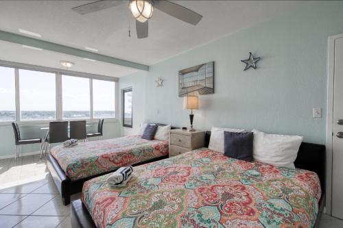 a hotel room with two beds and a table and chairs at Perfect Panorama - #905B in Fort Lauderdale