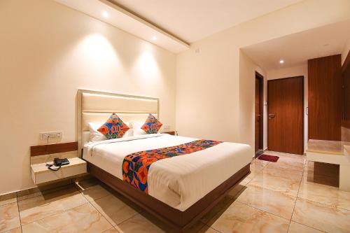 a bedroom with a large bed in a room at FabHotel High Rise - Marathalli in Bengaluru