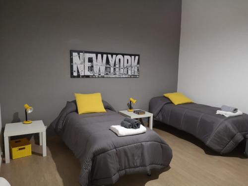 a room with two beds with yellow pillows at CASADEI24 in Guidonia