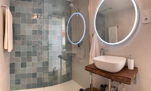 a bathroom with a sink and a shower with a mirror at Lovely beachfront apartment in Calahonda in Sitio de Calahonda