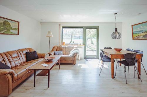 a living room with a couch and a table at Pederstrup Bed and Breakfast in Torrig