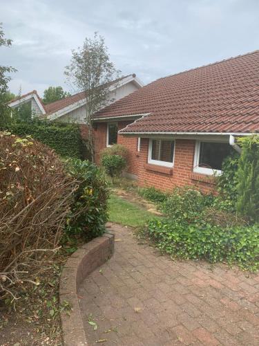 a brick house with a brick driveway in front of it at Casa Markskellet, Billund - hygge og leg for alle in Billund
