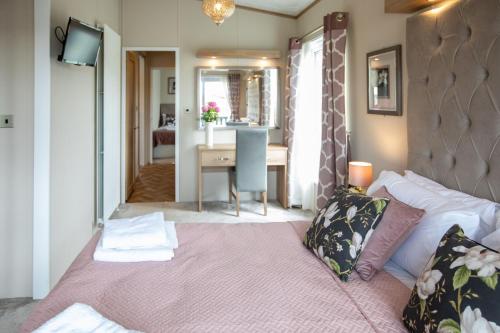 sypialnia z łóżkiem i biurkiem w pokoju w obiekcie Stewarts Resort Lodge 35 w mieście St Andrews