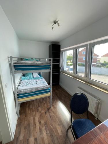 a room with a bunk bed and a table and chairs at Industriestraße in Belm in Belm