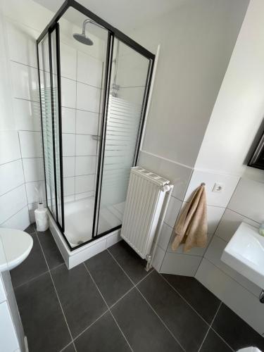 a bathroom with a shower and a toilet and a sink at Industriestraße in Belm in Belm