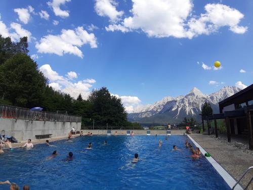 a group of people swimming in a swimming pool at Haubenschloss Apartment Kempten in Kempten