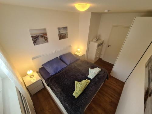 1 dormitorio pequeño con 1 cama y 2 lámparas en Pier 605 - 4 Sterne inklusive POWER WLAN - 2 Parkplätze - Wäschepaket #Bestpreisgarantie#, en Zingst