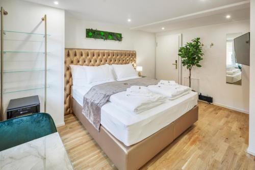 a bedroom with a large bed with white sheets at Steigerstrasse Apartments by VISIMO - Modern Living near OLMA & Hospital in St. Gallen