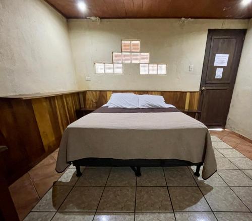 a bedroom with a bed in a room at Johnnys Place Hotel in Monterrico