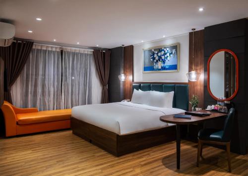 a hotel room with a bed and a desk at Bendecir Hotel & Spa in Hanoi