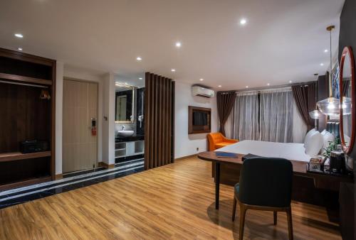 a living room with a table and a dining room at Bendecir Hotel & Spa in Hanoi