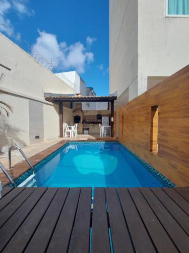 a swimming pool in a house with a wooden deck at Apple Flat Natal in Natal