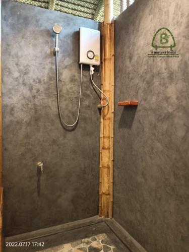 a shower stall in a bathroom with a shower at สวนเกษตรรักษ์ไผ่ Bamboo Conservation Farm in Surin
