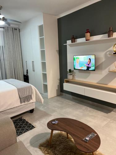 a living room with a tv on a wall at Sarona City L203 in Gaborone