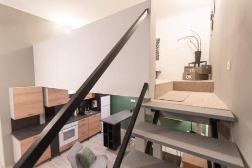 a room with a staircase with a desk and a couch at Central Stay Gozsdu in Budapest