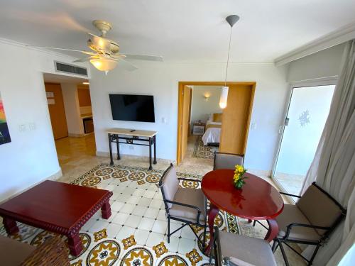 a living room with a red table and chairs at Hotel Las Americas Casa de Playa in Cartagena de Indias