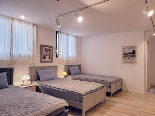 Postel nebo postele na pokoji v ubytování Picasso Guesthouse